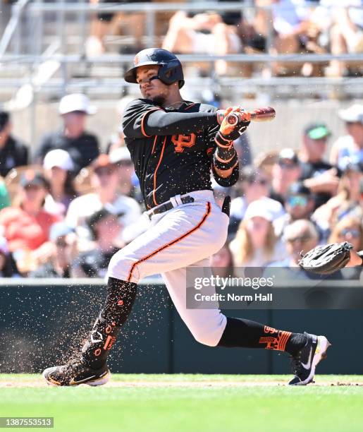 Thairo Estrada of the San Francisco Giants follows through on a swing against the Chicago White Sox during the second inning of a spring training...