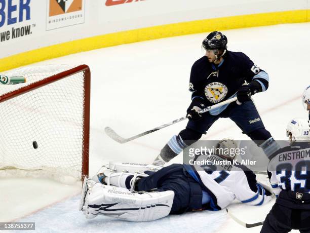 Kris Letang of the Pittsburgh Penguins scores past Ondrej Pavelec of the Winnipeg Jets during the game at Consol Energy Center on February 11, 2012...