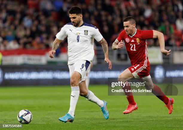 Aleksandar Mitrovic of Serbia leaves Endre Botka of Hungary behind during the international friendly match between Hungary and Serbia at Puskas Arena...