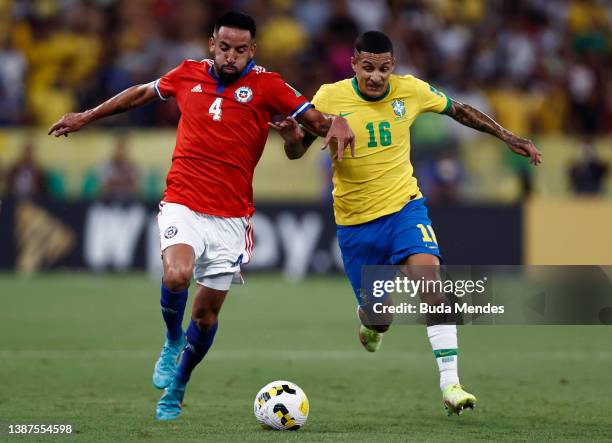 Mauricio Isla of Chile fights for the ball with Guilherme Arana of Brazil during a match between Brazil and Chile as part of FIFA World Cup Qatar...