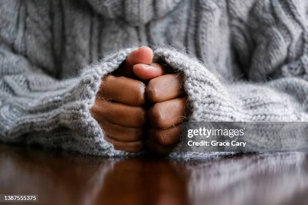 close-up of woman's hands on table - preoccupato foto e immagini stock