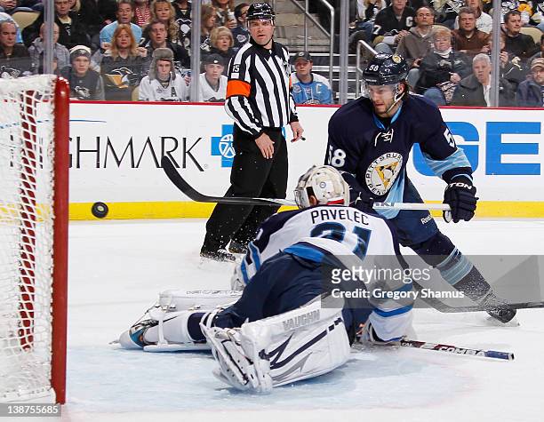Kris Letang of the Pittsburgh Penguins scores a goal against Ondrej Pavelec of the Winnipeg Jets on February 11, 2012 at Consol Energy Center in...