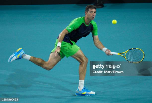 Federico Delbonis of Argentina returns a shot to Andy Murray of the United Kingdom during the 2022 Miami Open presented by Itaú at Hard Rock Stadium...