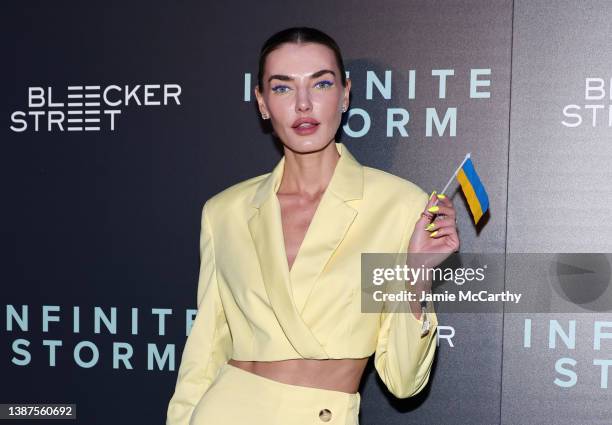 Alina Baikova holds the Ukrainian flag at the "Infinite Storm" screening at Regal Union Square on March 24, 2022 in New York City.