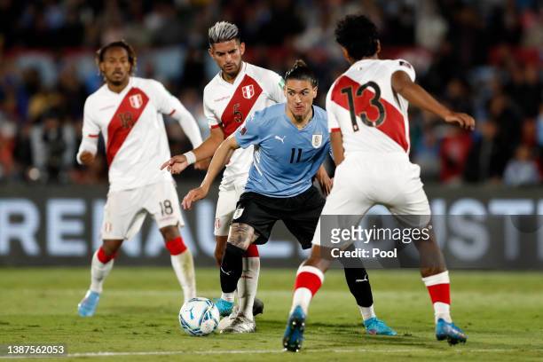 Darwin Núñez of Uruguay fights for the ball with Renato Tapia and Carlos Zambrano of Peru during a match between Uruguay and Peru as part of FIFA...