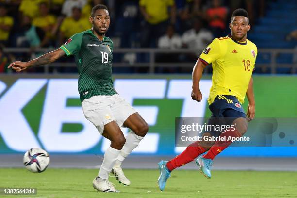 Frank Fabra of Colombia kicks the ball against Marc Enoumba of Bolivia during a match between Colombia and Bolivia as part of FIFA World Cup Qatar...