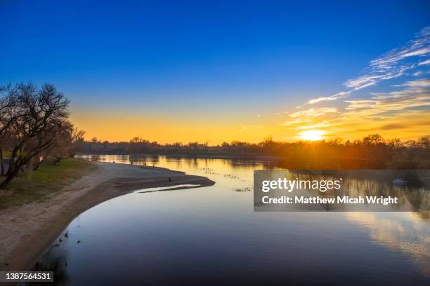 a sunset over the sacramento river. - zephyros stock-fotos und bilder