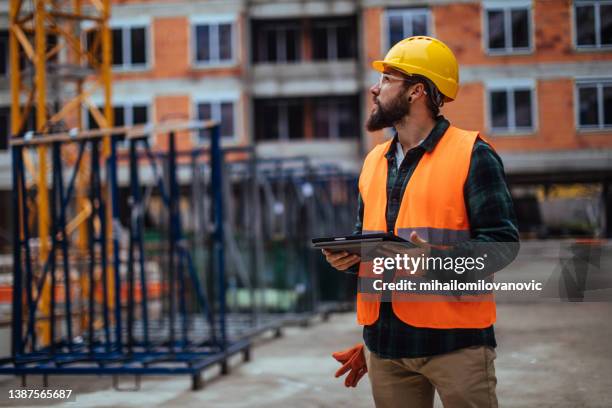 supervising the construction process - construction industry 2021 stock pictures, royalty-free photos & images