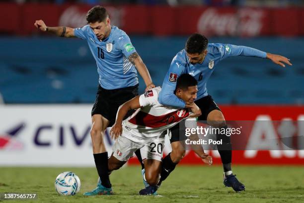 Edison Flores of Peru fights for the ball with Rodrigo Bentancur and Federico Valverde of Uruguay during a match between Uruguay and Peru as part of...