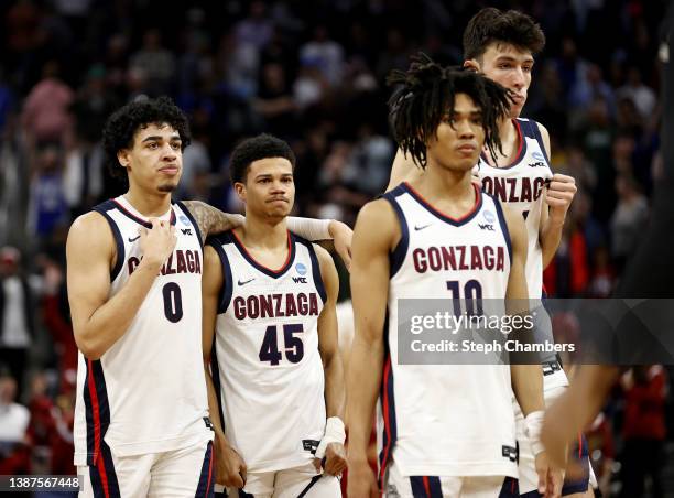 Gonzaga Bulldogs team members Julian Strawther, Rasir Bolton, and Hunter Sallis react after losing to the Arkansas Razorbacks with a final score of...