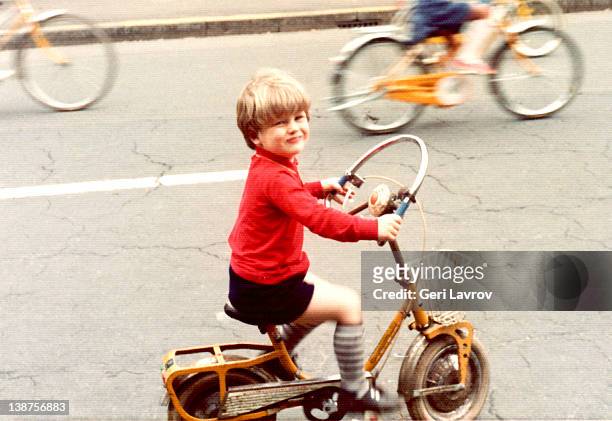 young boy riding bicycle - early childhood stock pictures, royalty-free photos & images