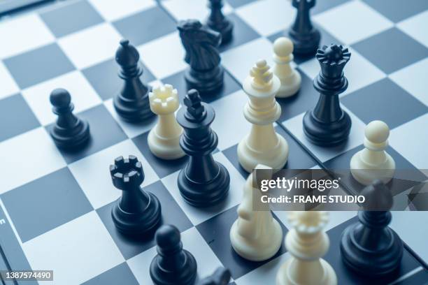 chess board game white and black chessmen - battle plan stock pictures, royalty-free photos & images