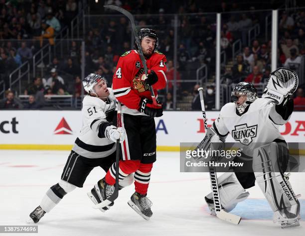 Boris Katchouk of the Chicago Blackhawks attempts a deflection in front of Troy Stecher and Jonathan Quick of the Los Angeles Kings during the first...
