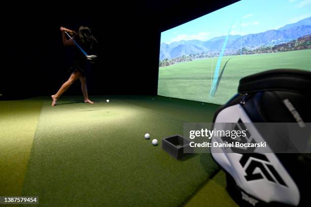 Guests compete in a golf simulator competition during the PXG Chicago West Grand Opening Celebration on March 24, 2022 in Chicago, Illinois.