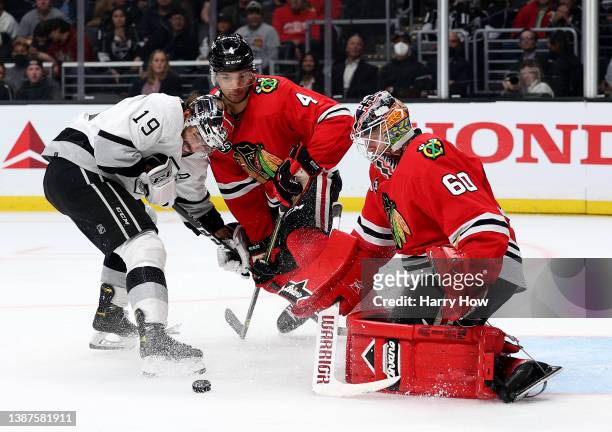 Collin Delia of the Chicago Blackhawks makes a save in front of Alex Iafallo of the Los Angeles Kings and Seth Jones during the second period at...