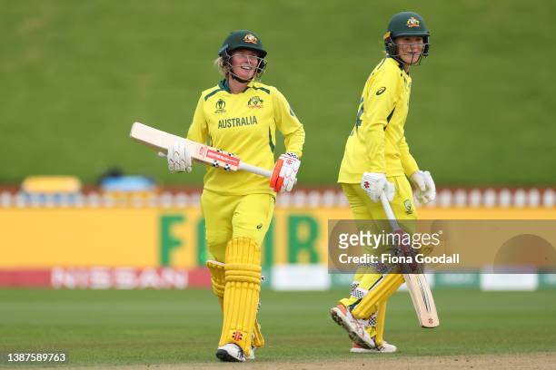 Beth Mooney of Australia celebrates after she hits a four with Annabel Sutherland of Australia (during the 2022 ICC Women's Cricket World Cup match...