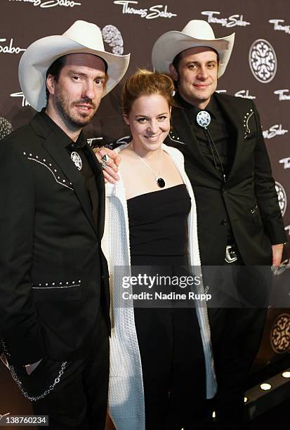 Alec Voelkel, Bernadette Heerwagen and Sascha Vollmer of the BossHoss attend the Thomas Sabo Party at Postpalast on February 11, 2012 in Munich,...