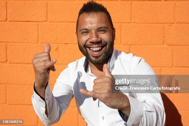expressive black man showing rock gesture - protruding stock pictures, royalty-free photos & images