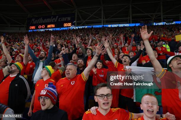 The Welsh fans sin the natinal anthem prior to the 2022 FIFA World Cup Qualifier knockout round play-off match between Wales and Austria at Cardiff...