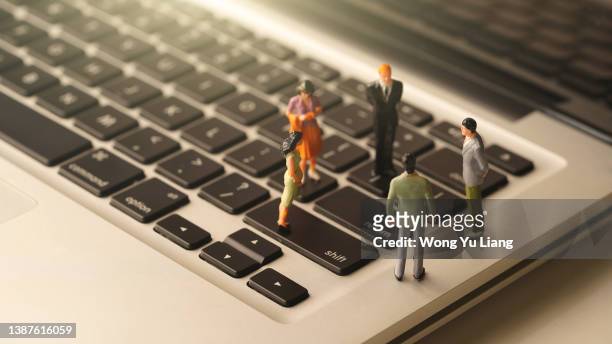 miniature business people  on keyboard concept photo - figurine ストックフォトと画像