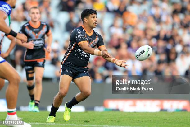 Tyrone Peachey of the Tigers passes the ball during the round three NRL match between the Wests Tigers and the New Zealand Warriors at Campbelltown...