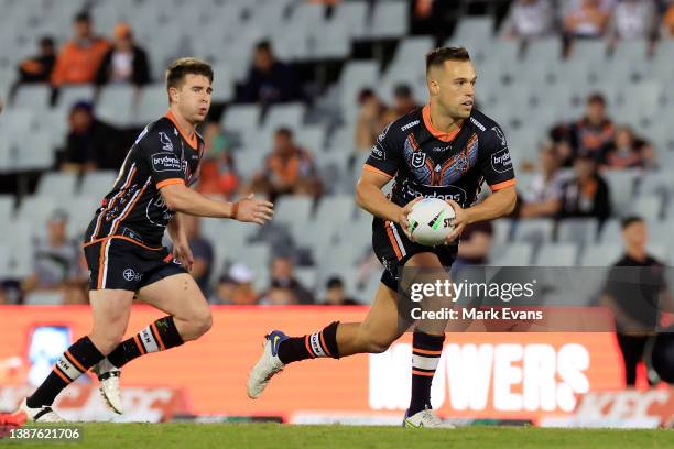 Luke Brooks of the Tigers runs the ball during the round three NRL match between the Wests Tigers and the New Zealand Warriors at Campbelltown...