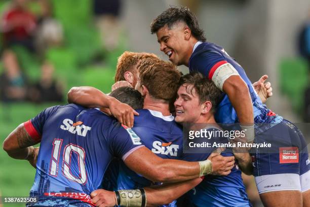 Rebels players celebrate after Ray Nu'u of the Rebels scored a try during the round six Super Rugby Pacific match between the Melbourne Rebels and...