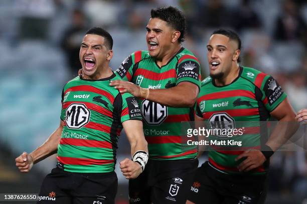 Cody Walker of the Rabbitohs celebrates with Latrell Mitchell and Keaon Koloamatangi of the Rabbitohs after scoring a try during the round three NRL...