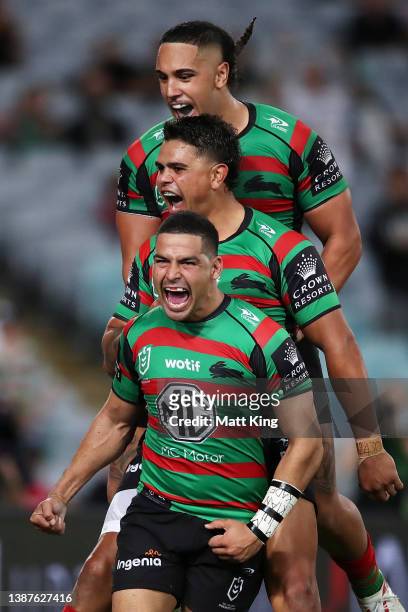 Cody Walker of the Rabbitohs celebrates with Latrell Mitchell and Keaon Koloamatangi of the Rabbitohs after scoring a try during the round three NRL...