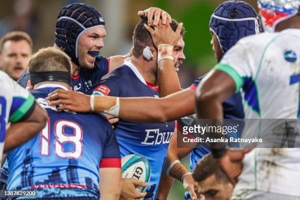 Cameron Orr of the Rebels is congratulated by his teammates after scoring a try during the round six Super Rugby Pacific match between the Melbourne...