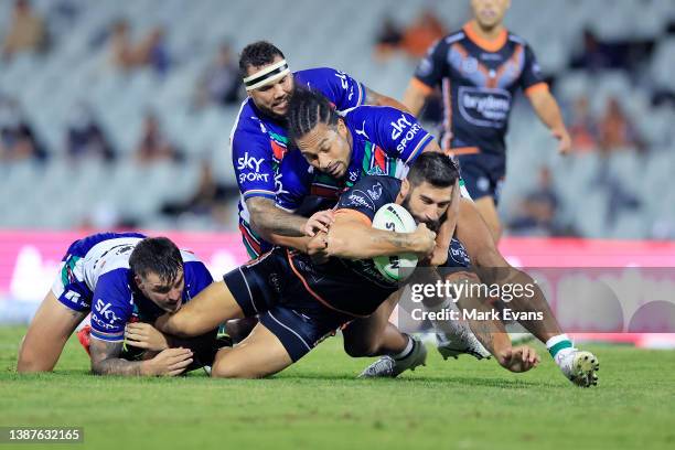 James Tamou of the Tigers is tackled during the round three NRL match between the Wests Tigers and the New Zealand Warriors at Campbelltown Stadium,...