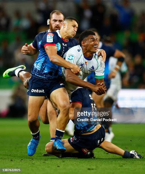 Kitione Salawa of Fijian Drua passes the ball whilst being tackled by Reece Hodge of the Rebels during the round six Super Rugby Pacific match...