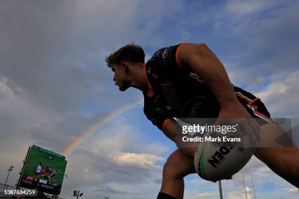 Jake Simpkin of the Tigers warms up on the side of the field during the round three NRL match between the Wests Tigers and the New Zealand Warriors...