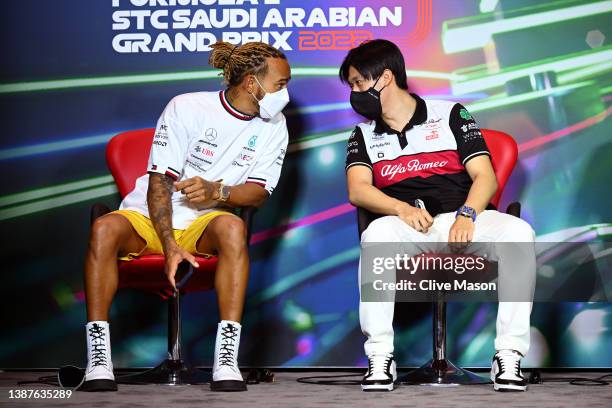 Lewis Hamilton of Great Britain and Mercedes and Zhou Guanyu of China and Alfa Romeo F1 talk in the Drivers Press Conference before practice ahead of...