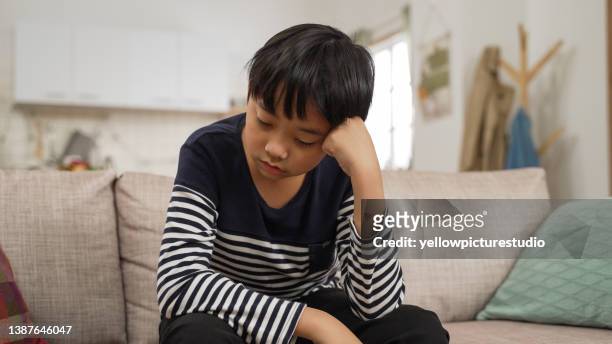 young asian preteen teenager boy feel depressed in his bedroom with, cyberbullying in kid, depressed child mental health, social distancing concept - asian violence stock pictures, royalty-free photos & images