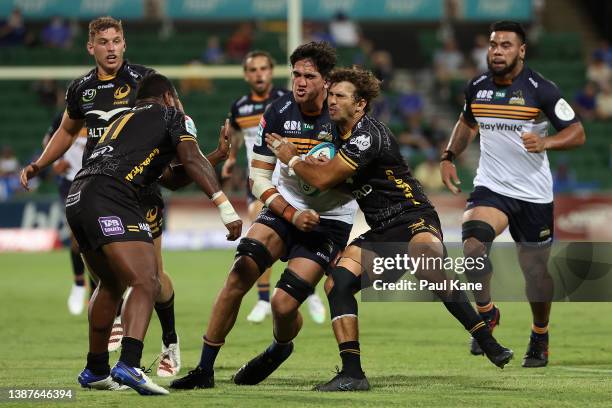 Darcy Swain of the Brumbies gets tackled by Jake Strachan of the Force during the round six Super Rugby Pacific match between the Western Force and...