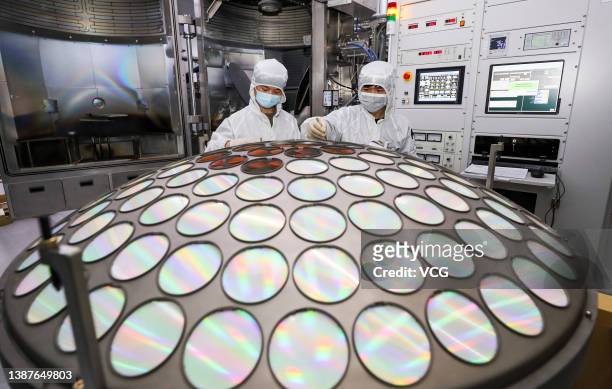 Employees work on the production line of LED epitaxial wafer at a factory of Jiangsu Azure Corporation Cuoda Group Co., Ltd on March 25, 2022 in Huai...