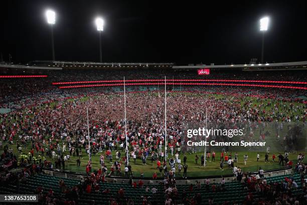 Lance Franklin of the Swans celebrates kicking his 1000th AFL goal as fans run onto the field to congratulate him during the round two AFL match...