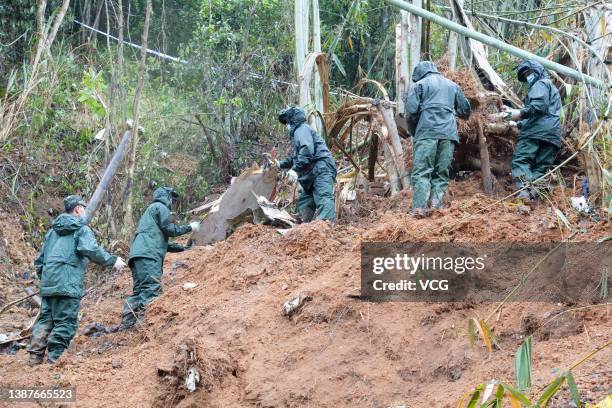 Rescuers work at the site of a plane crash on March 23, 2022 in Tengxian County, Wuzhou City, Guangxi Zhuang Autonomous Region of China. A China...