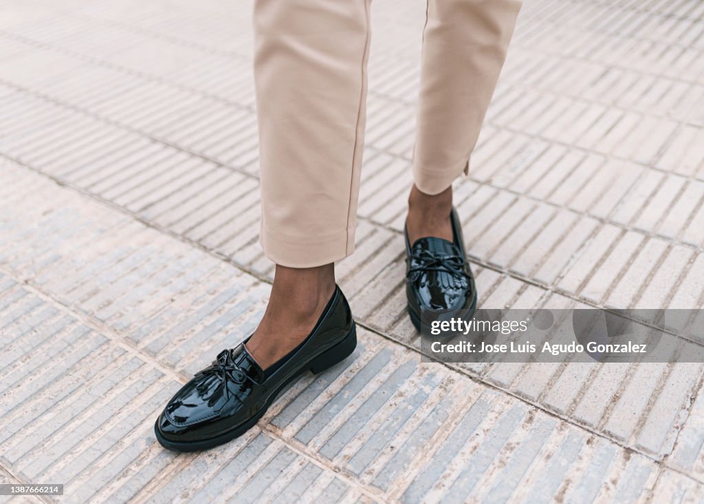 Close up of a girl with patent leather shoes, close up of a woman walking with shoes