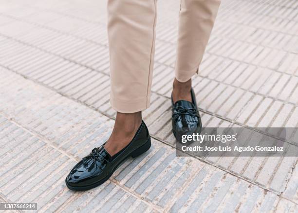 close up of a girl with patent leather shoes, close up of a woman walking with shoes - classical style stock-fotos und bilder