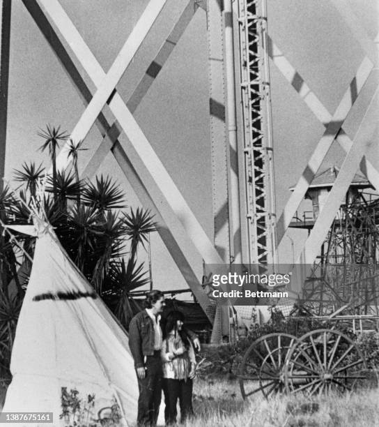 Two Native American activists beside a teepee erected on Alcatraz Island during during their occupation of the island in San Francisco Bay,...