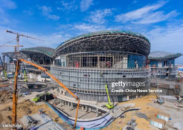 Cranes stand at the construction site of Haikou International Duty Free City Complex, one of the major projects of the China Pilot Free Trade Zone,...