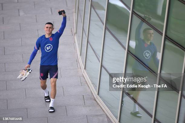 Phil Foden of England reacts as he walks to a training session at St Georges Park on March 25, 2022 in Burton-upon-Trent, England.