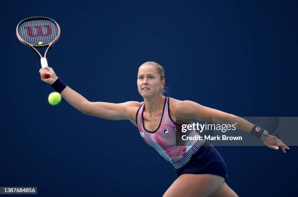 Shelby Rogers of United States returns a shot to Jeļena Ostapenko of Latvia during the 2022 Miami Open presented by Itaú at Hard Rock Stadium on...