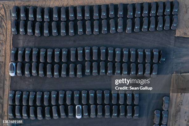 In this aerial view newly completed Tesla Model Y electric cars stand at the new Tesla Gigafactory electric car manufacturing plant on March 25, 2022...