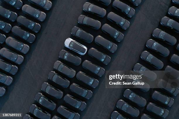 In this aerial view newly completed Tesla Model Y electric cars stand at the new Tesla Gigafactory electric car manufacturing plant on March 25, 2022...