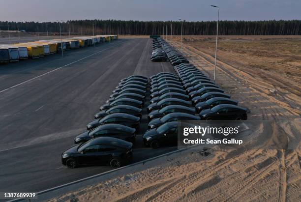 In this aerial view, newly completed Tesla Model Y electric cars stand at the new Tesla Gigafactory electric car manufacturing plant on March 25,...