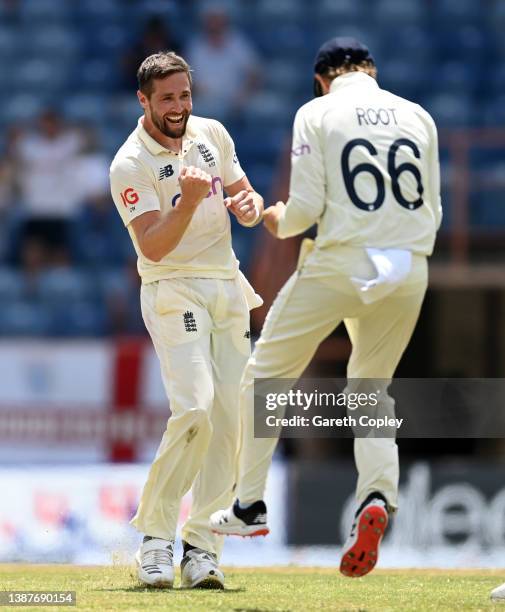 Chris Woakes of England celebrates with Joe Root after dismissing Jason Holder of the West Indies during day two of the 3rd Test match between the...