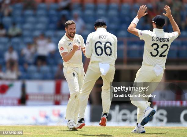 Chris Woakes of England celebrates with Joe Root after dismissing Jason Holder of the West Indies during day two of the 3rd Test match between the...